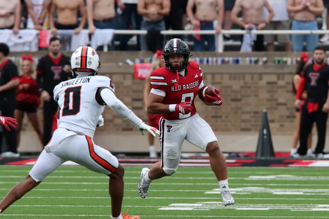 Sep 13, 2025; Lubbock, Texas, USA; Texas Tech Red Raiders running back Cameron Dickey (8) rushes against Oregon State Beavers defensive back Kobe Singleton (0) in the first half at Jones AT & T Stadium. Mandatory Credit: Michael C. Johnson-Imagn Images