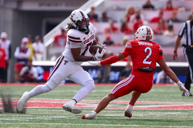 Sep 20, 2025; Salt Lake City, Utah, USA; Texas Tech Red Raiders tight end Terrance Carter Jr. (7) runs after a catch against Utah Utes cornerback Smith Snowden (2) during the second quarter at Rice-Eccles Stadium. Mandatory Credit: Rob Gray-Imagn Images