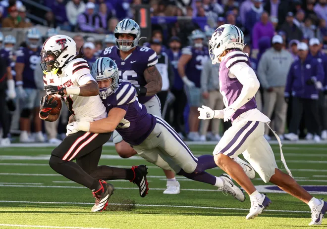 Nov 1, 2025; Manhattan, Kansas, USA; Kansas State Wildcats linebacker Rex Van Wyhe (28) tackles Texas Tech Red Raiders tight end Terrance Carter Jr. (7) during the third quarter at Bill Snyder Family Football Stadium. Mandatory Credit: Scott Sewell-Imagn Images