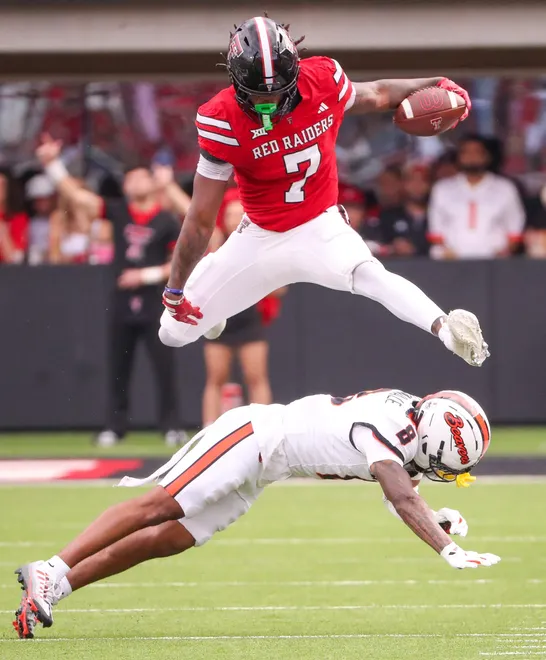 Texas Tech's Terrance Carter Jr. hurdles an Oregon State defender during a non-conference football game, Saturday, Sept. 13, 2025, at Jones AT & T Stadium.