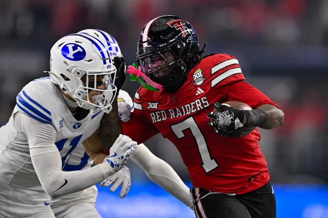Dec 6, 2025; Arlington, TX, USA; BYU Cougars safety Faletau Satuala (11) tackles Texas Tech Red Raiders tight end Terrance Carter Jr. (7) during the game between the Red Raiders and the Cougars at AT & T Stadium. Mandatory Credit: Jerome Miron-Imagn Images