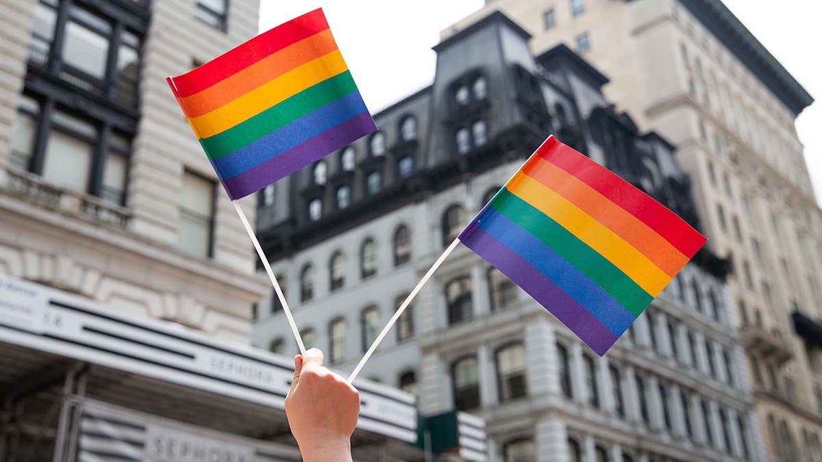 An attendee holds up flags