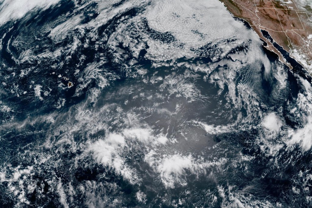 Satellite image of extreme tropical weather over the Pacific Ocean, with Hawaii and parts of North America visible.