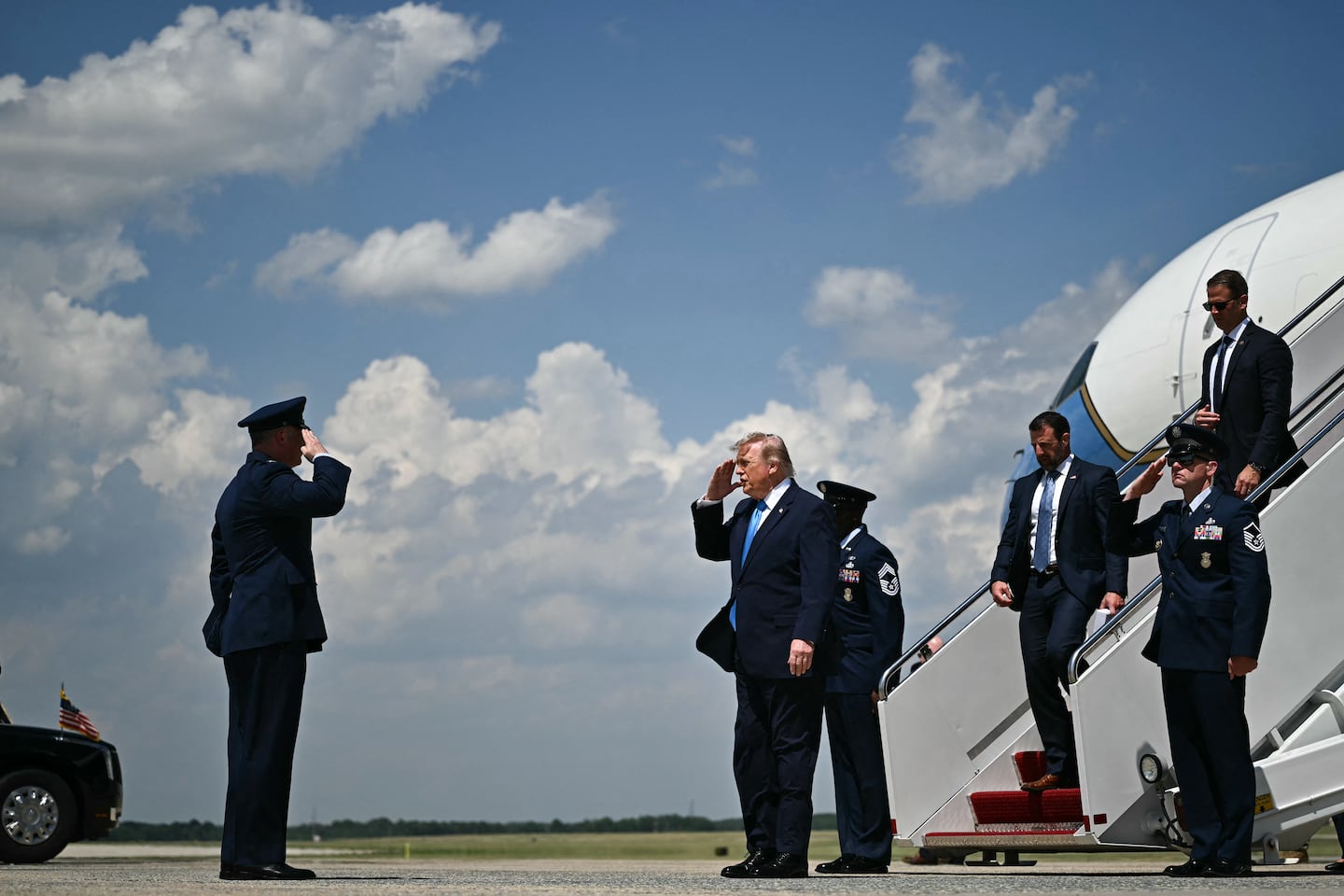 President Trump, trailed by Secretary of Homeland Security Markwayne Mullin, saluted as he exits Air Force One at Joint Base Andrews, Maryland, on May 20.