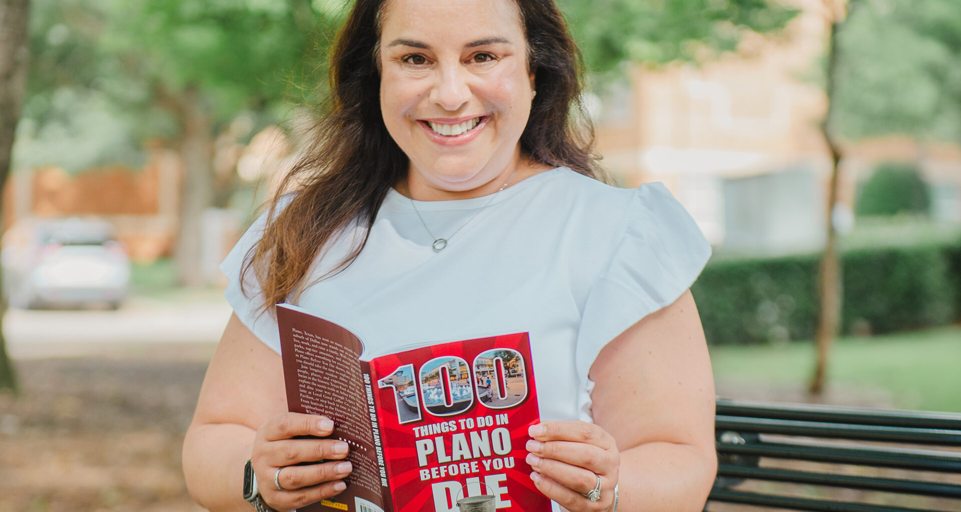 Abbie Alter with her book "100 Things to Do in Plano Before You Die." Photography by Lauren Allen