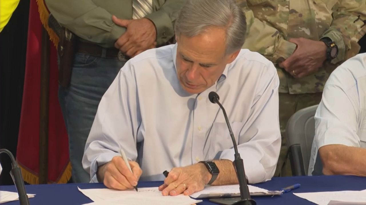 Texas Gov. Greg Abbott signing a major disaster declaration in Uvalde County on Friday, July 17, 2026. (Spectrum News 1)