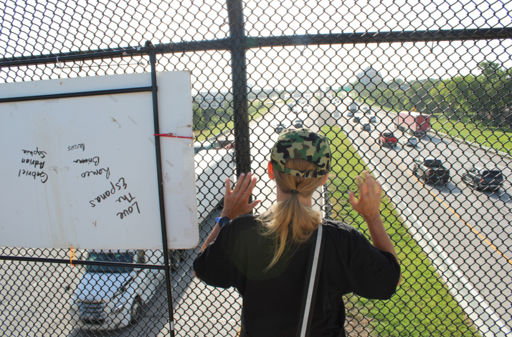 Activist in Arlington looks out onto I-30.