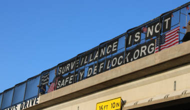 Activists display a sign reading "Surveillance is not safety" in Arlington.