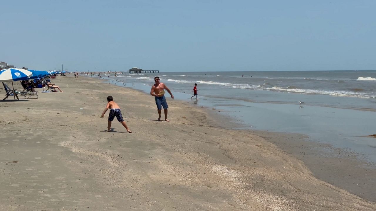 Galveston beachgoers braved the heat, potential storm