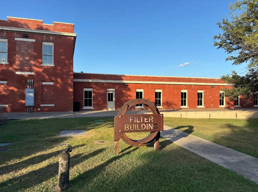 White Rock Filter Building with sign in front of building.