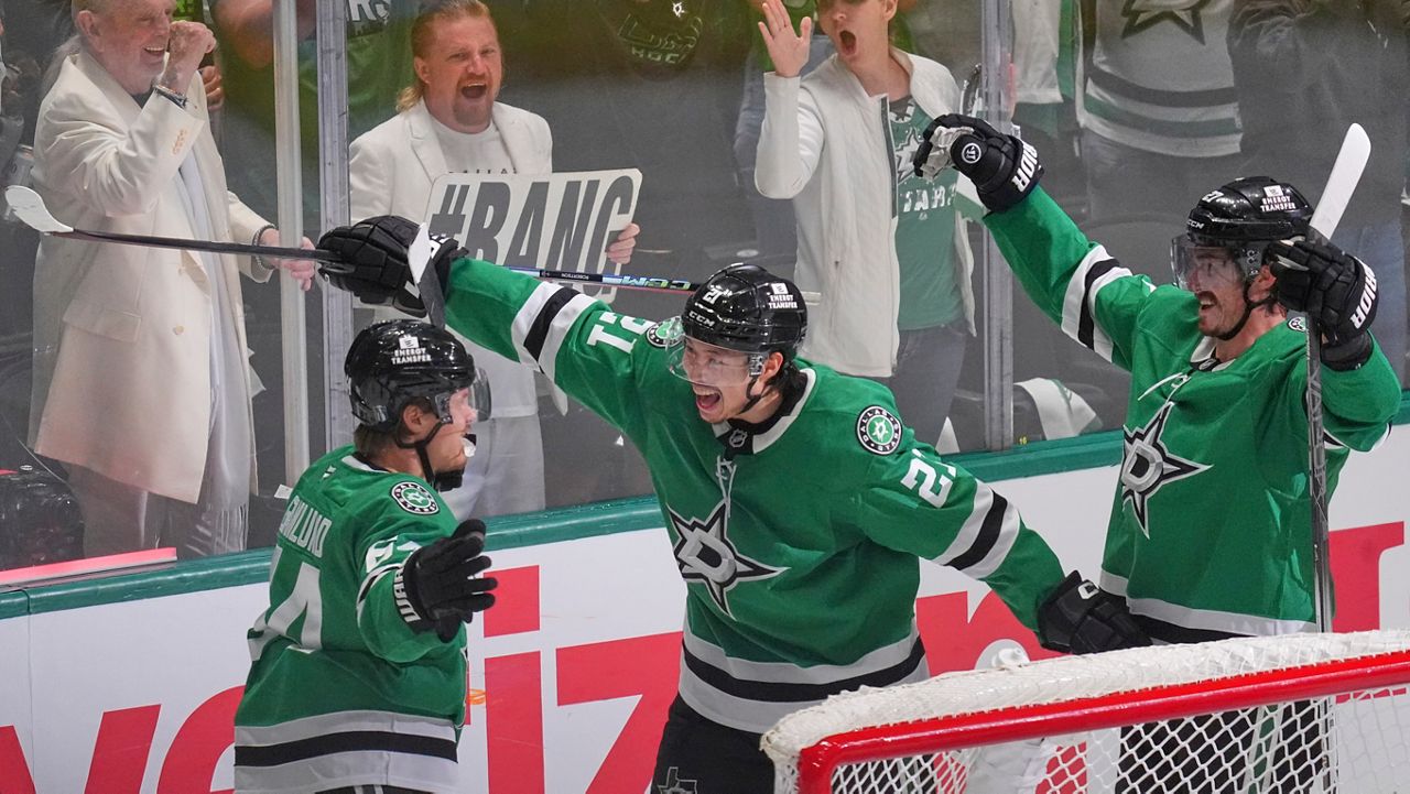 Dallas Stars center Mikael Granlund (64) celebrates a goal with teammates Jason Robertson (21) and Mason Marchment during the third period in Game 1 of the Western Conference finals in the NHL hockey Stanley Cup playoffs against the Edmonton Oilers, Wednesday, May 21, 2025, in Dallas. (AP Photo/LM Otero)