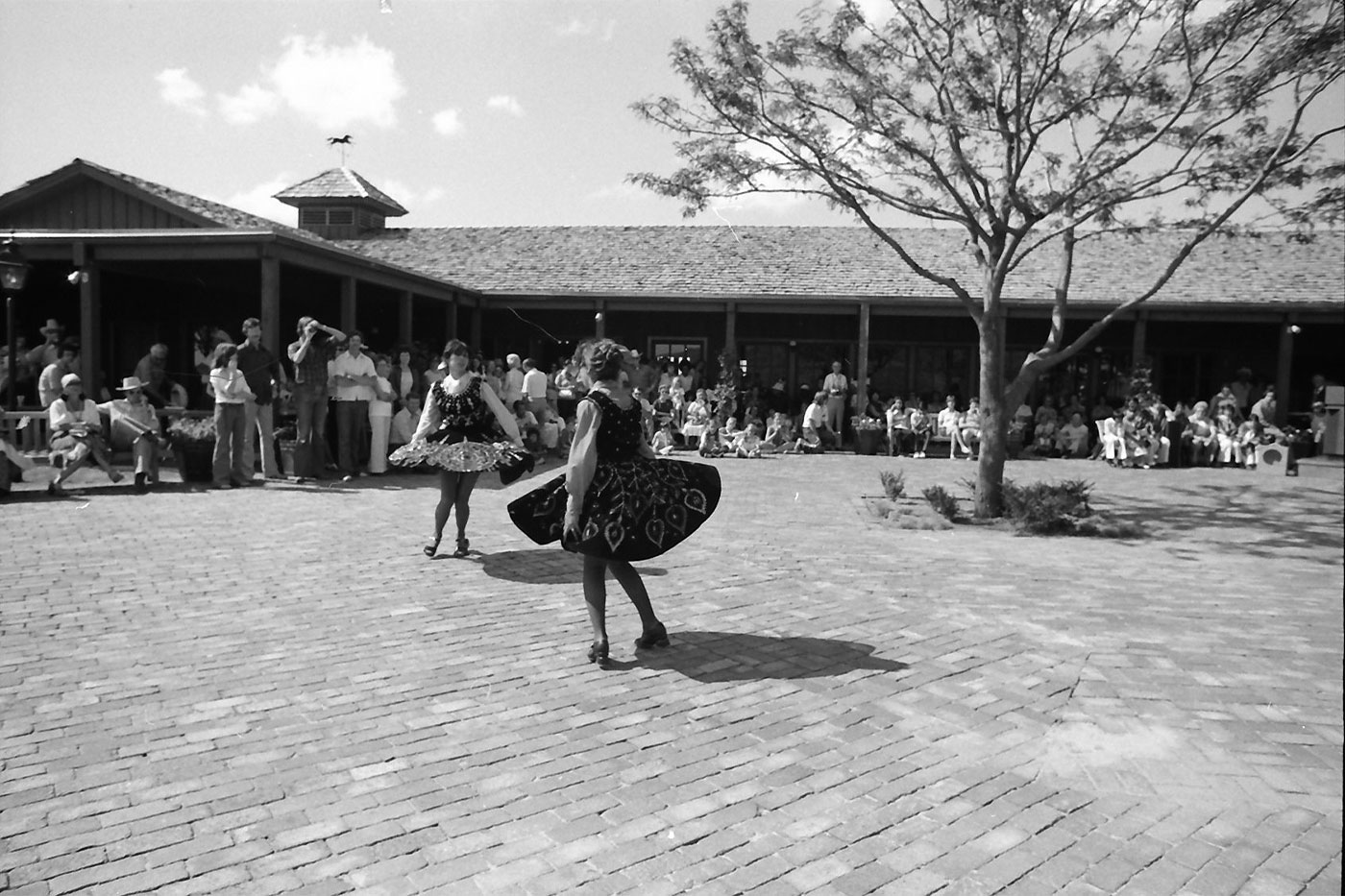 Women dancing in authentic western wear at dedication