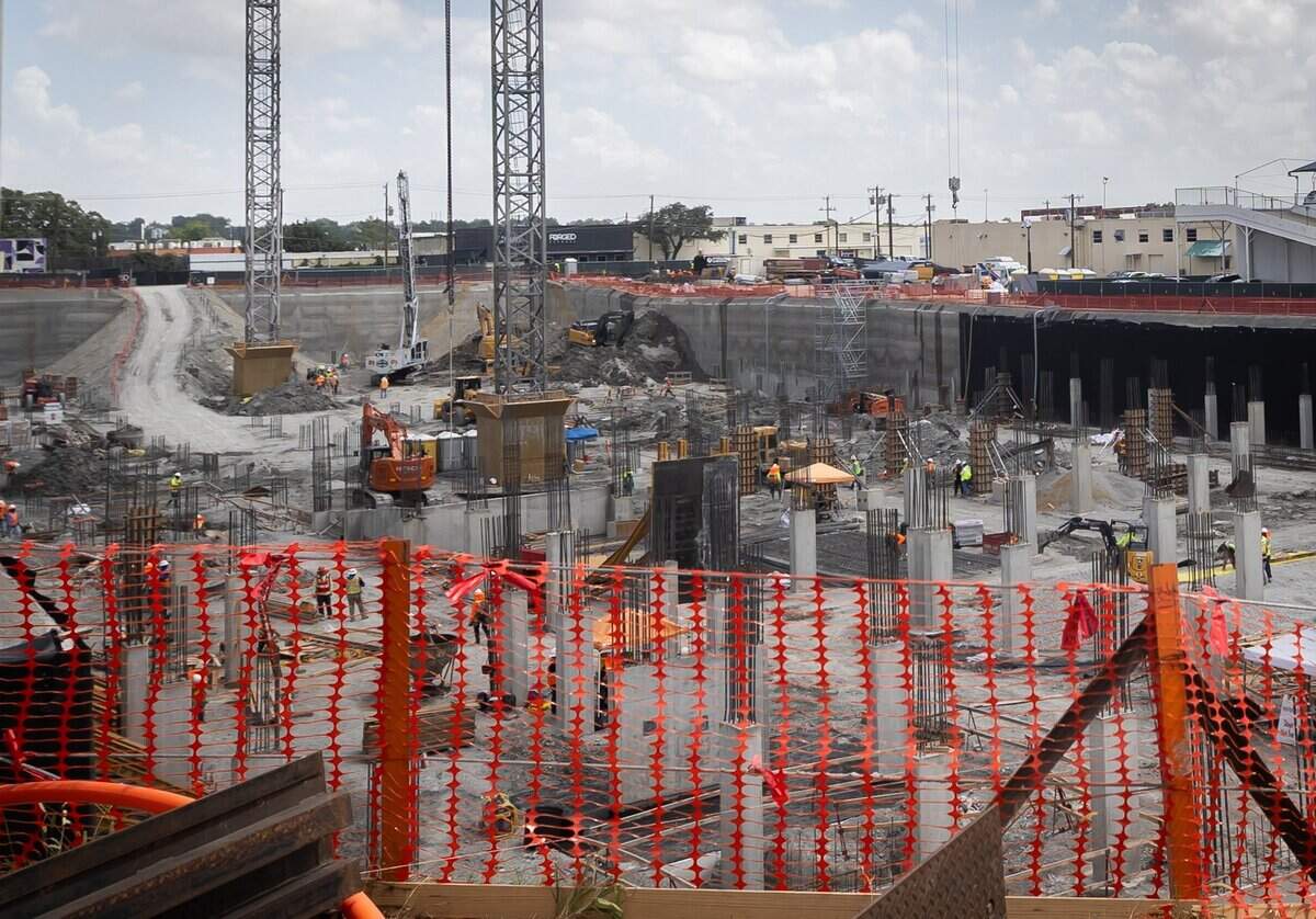 Construction workers work on a building on University Drive in Fort Worth on July 15, 2026.