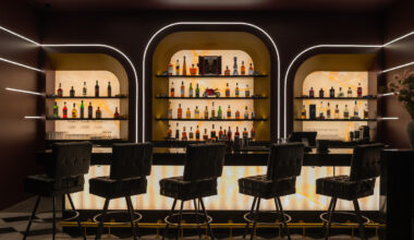 Forget standard bars: A 50-person racing speakeasy hidden behind mounted steering wheels opens in Houston's Sawyer Yards