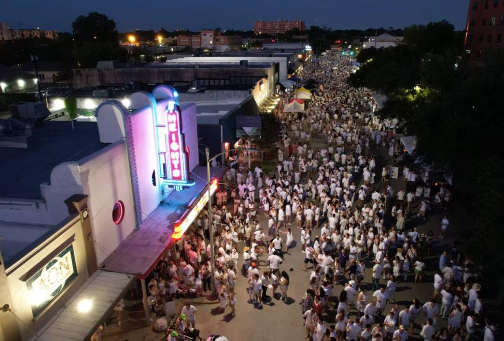 Image shows a huge crowd of people wearing white linen in The Heights for White Linen Nights. 