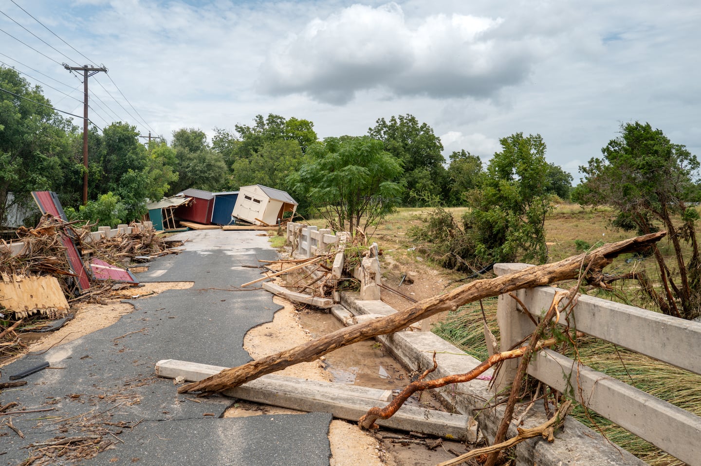 Sheds are displaced near an overpass on the banks of the Guadalupe River on July 17, 2026 in Kerrville, Texas. Flash floods swept across parts of Central Texas, bringing torrential rainfall, prompting evacuations, and triggering hundreds of water rescues. At least two people have been killed, and more than 200 others have been rescued.