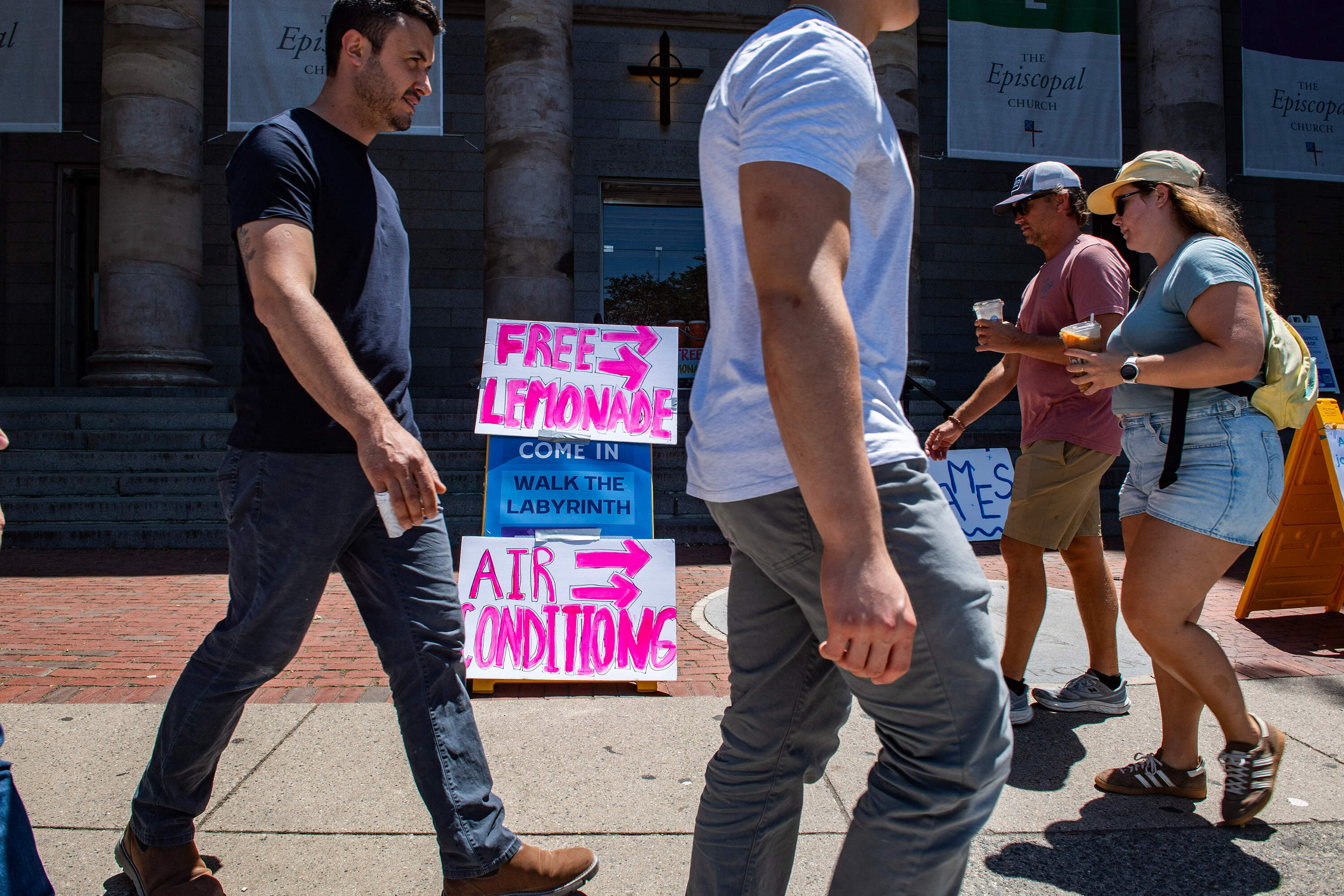 A sign offering air conditioning and free lemonade stands outside of a church in downtown Boston on July 1, 2026. (Joseph Prezioso/AFP via Getty Images)