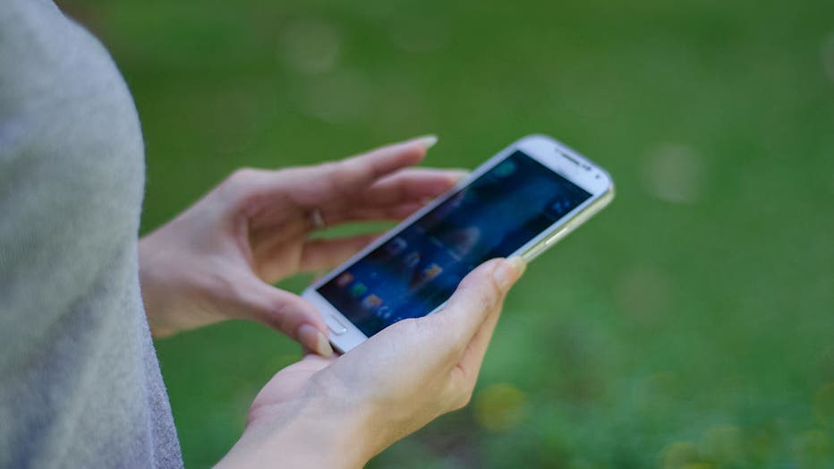 FILE - Close up of young woman holding a smartphone. (Photo: Elizabeth Fernandez / Contributor via Getty Images)