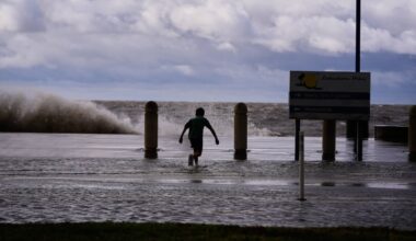 Josiah Carpenter frolics in the floodwaters on Lakeshore Drive along Lake Pontchartrain as Tropical Storm Bertha approaches the Louisiana Coast on July 22, in New Orleans.