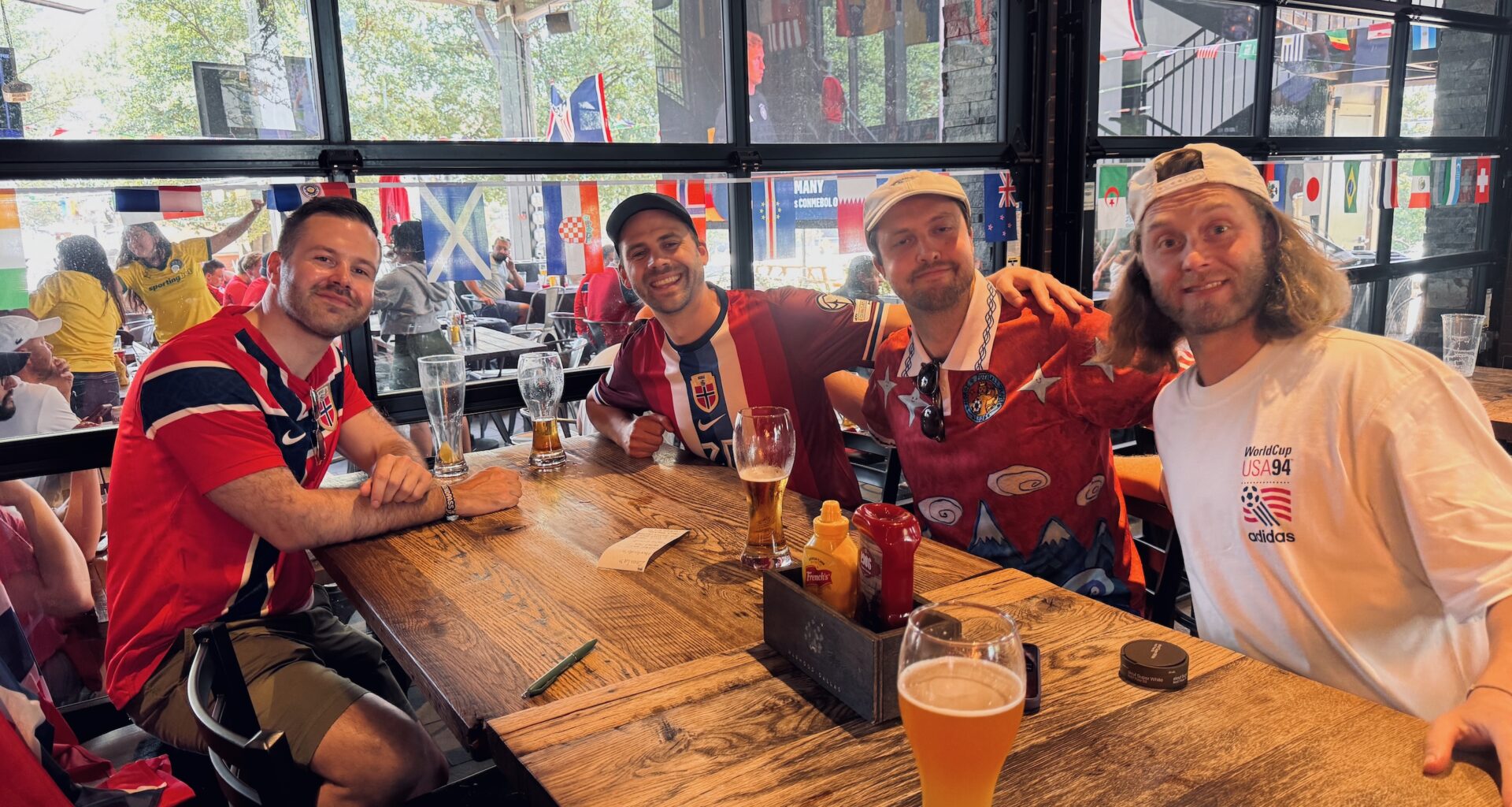 four men sitting at a table in a bar in Dallas