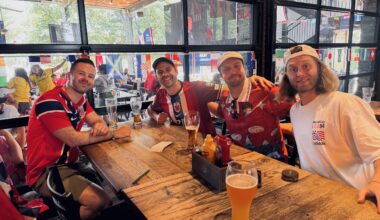 four men sitting at a table in a bar in Dallas