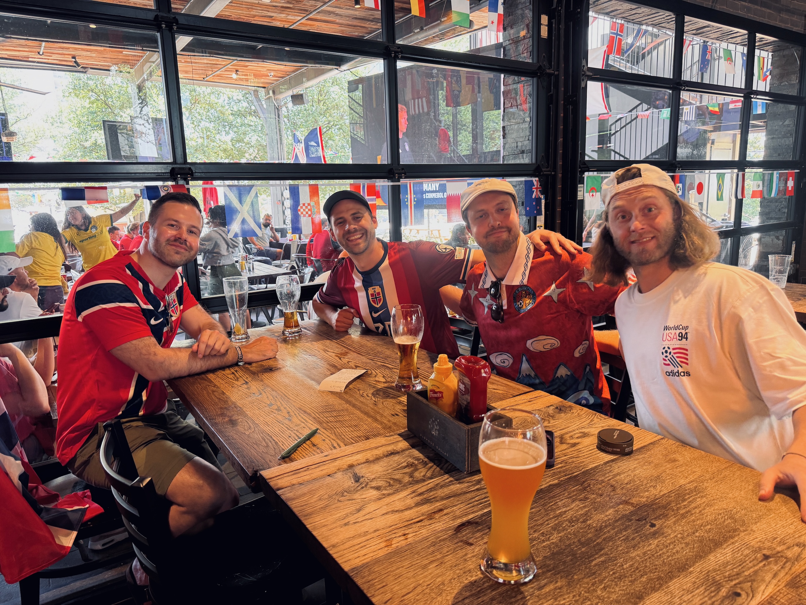 four men sitting at a table in a bar in Dallas