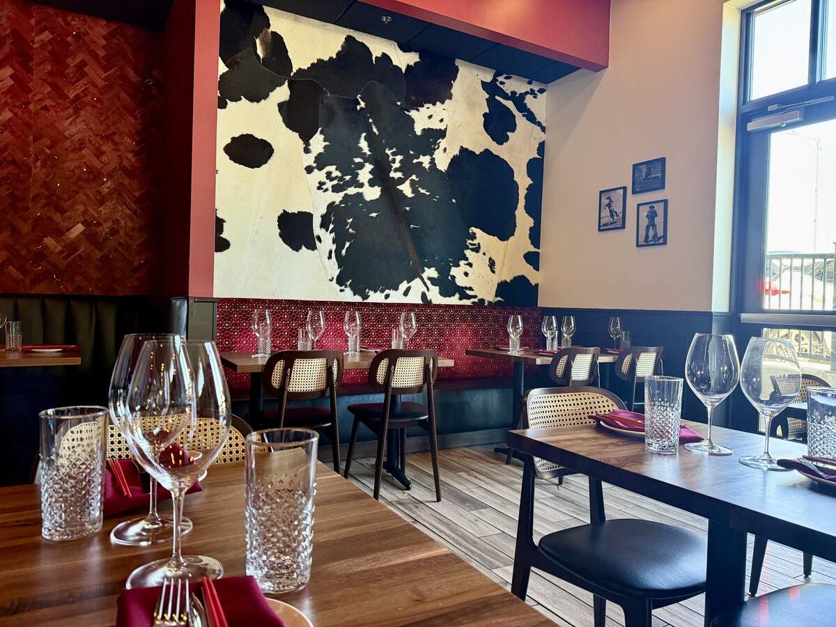 The decor at Teddy Wong’s Dumplings & Wine in Weatherford, with a window view of U.S. 180 traffic on Palo Pinto Street,