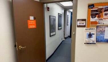 An open door leads into the KTEP-FM studios at the University of Texas at El Paso. A sign identifies the entrance as “206 KTEP FM Studios,” while campus flyers hang on a bulletin board outside the studio hallway.
