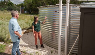 Dr. Robert Mace and Katie Tritsch look at a gauge that shows the water level in the collection tank.