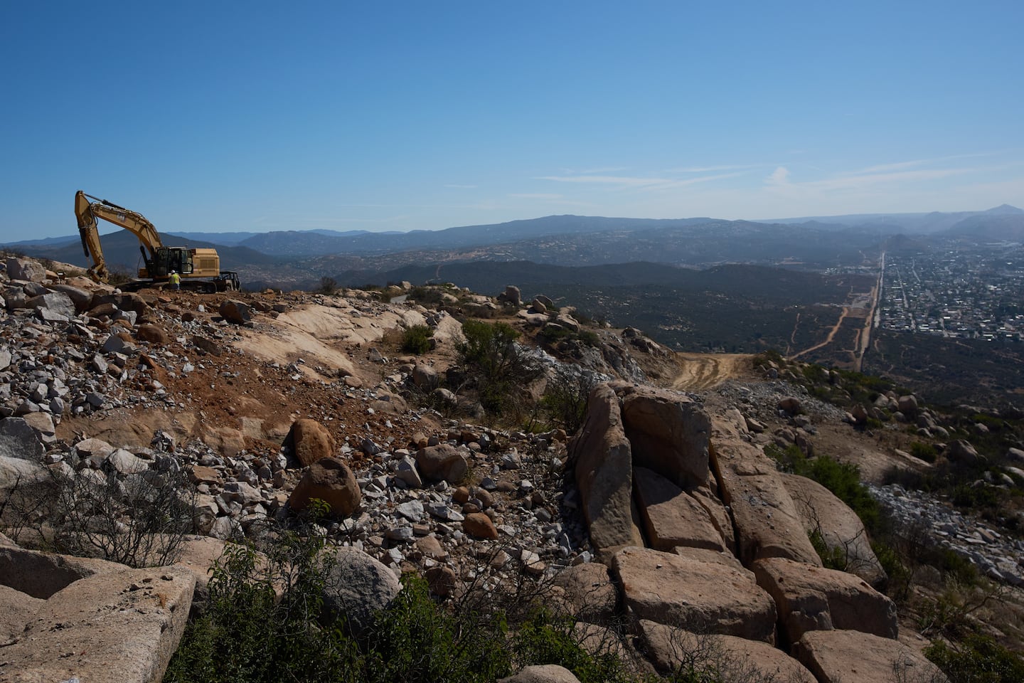 Construction crews worked on a new border wall segment on Kuuchamaa Mountain, on April 24, seen from Tecate, Mexico. 
