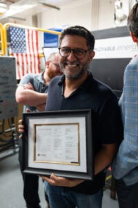 image of a man holding a signed letter
