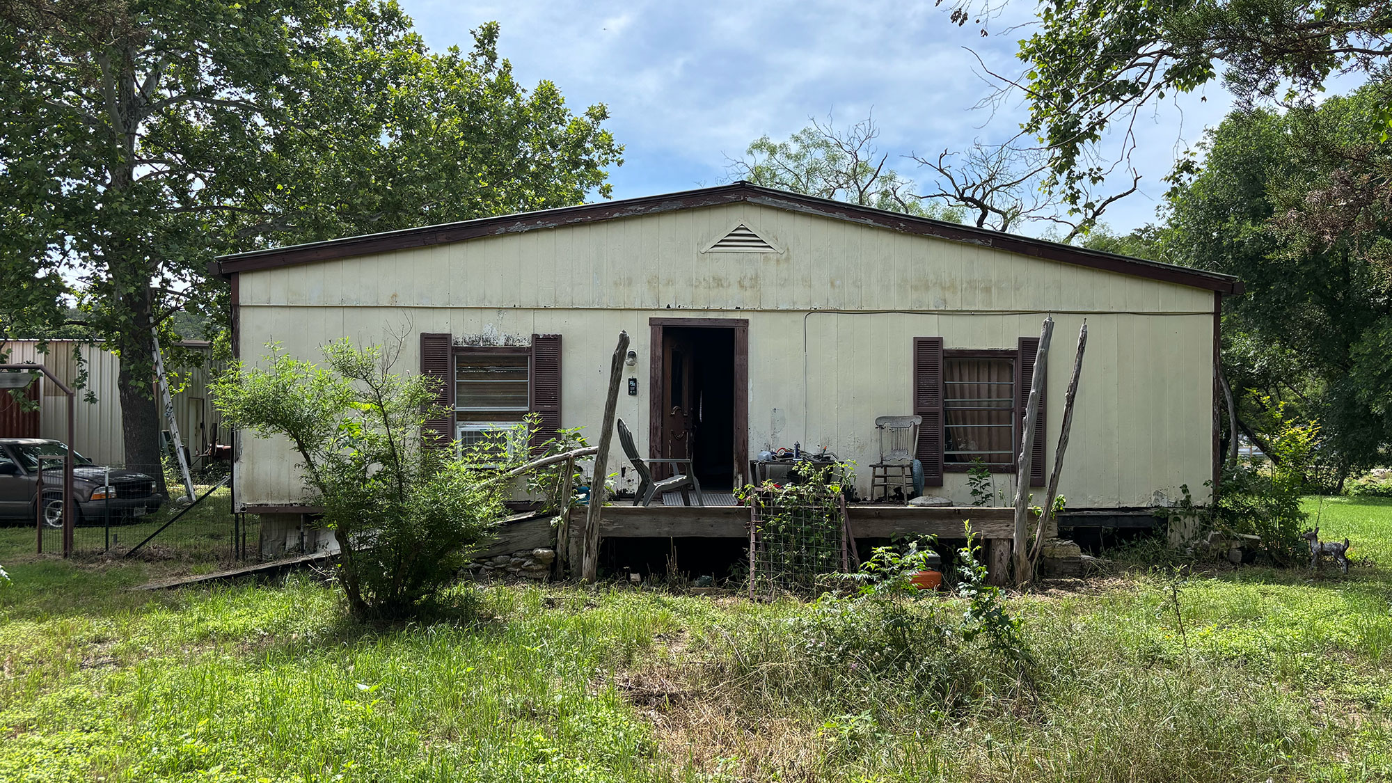A flood-damaged home with boarded up windows