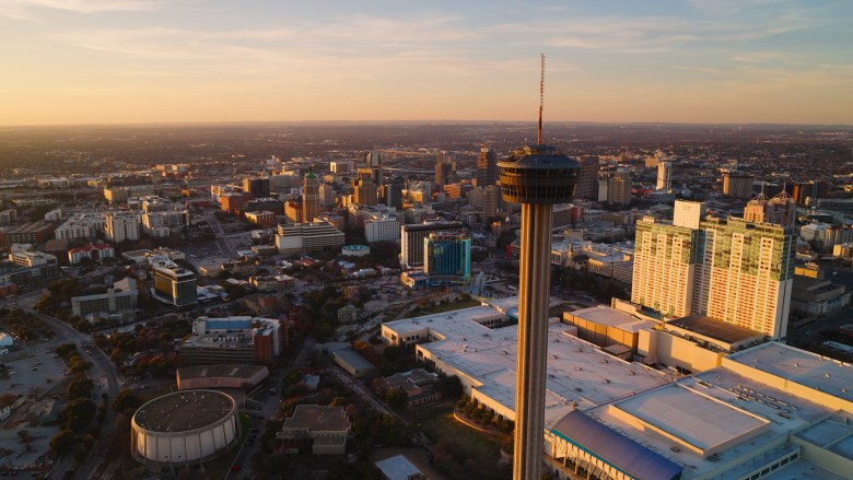 An aerial shot shows the expanding San Antonio skyline.