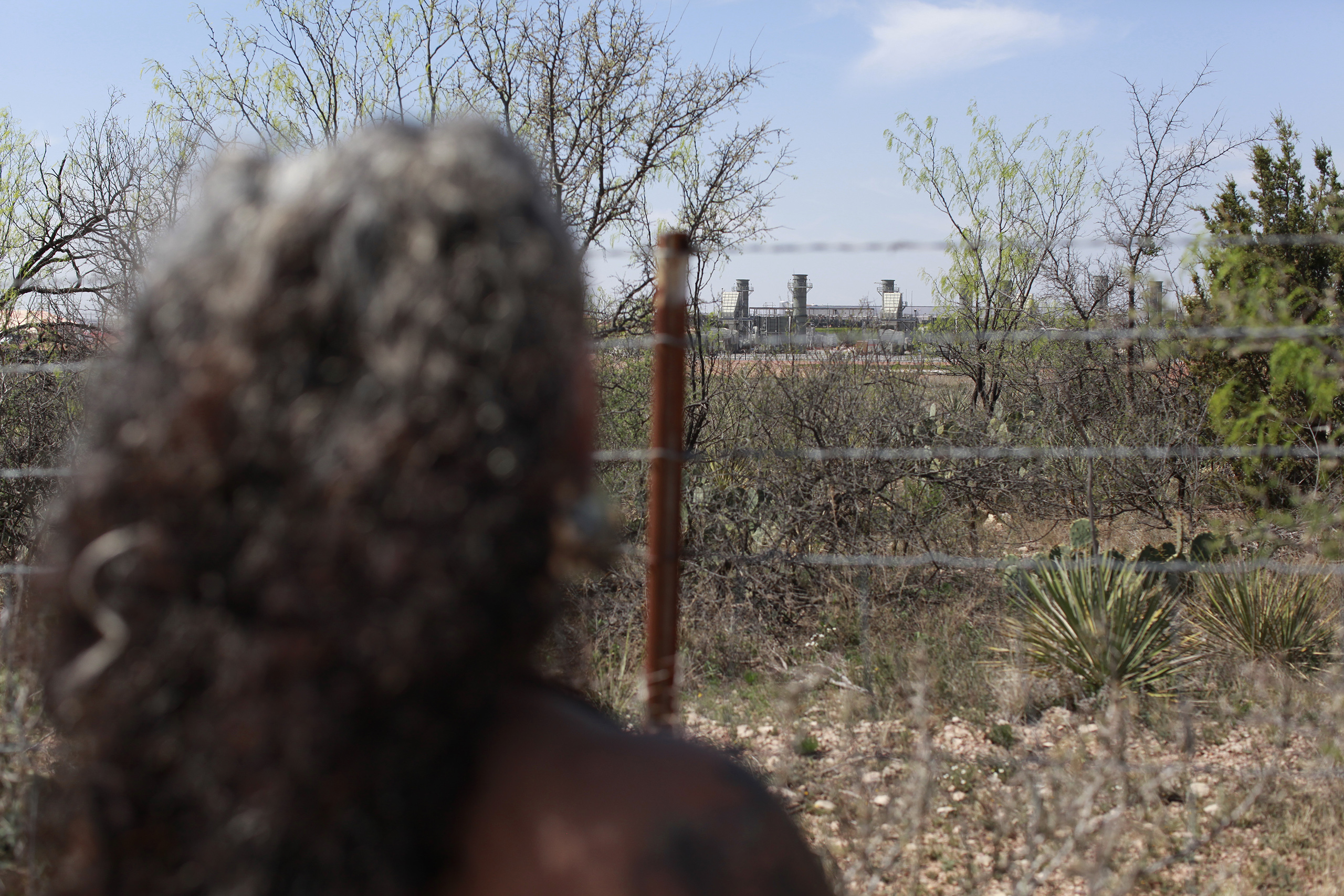 Omaira Garcia stands at her property line bordering OpenAI’s flagship “Stargate” data center in Abilene, Texas. The data center’s gas-fueled power plant is located roughly 500 yards from her home.