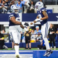 Dec 21, 2025; Arlington, Texas, USA; Dallas Cowboys wide receiver Ryan Flournoy (19) celebrates with guard Tyler Booker (52) after catching a touchdown pass against the Los Angeles Chargers during the first quarter at AT&T Stadium.