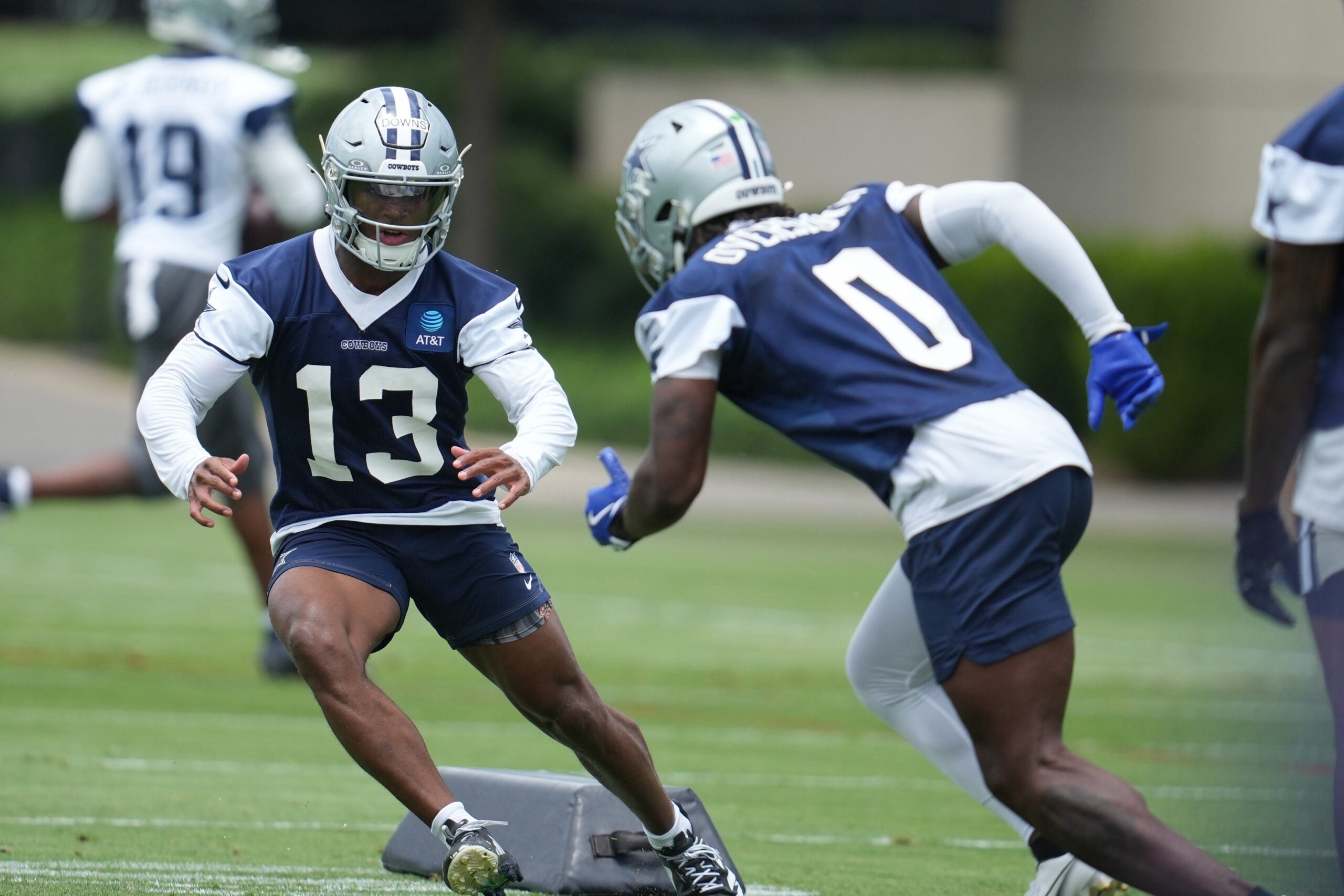 Jun 16, 2026; Dallas, TX, USA; Dallas Cowboys safety Caleb Downs (13) and linebacker DeMarvion Overshown (0) go through a drill during practice at the Ford Center at the Star Training Facility in Frisco, Texas.