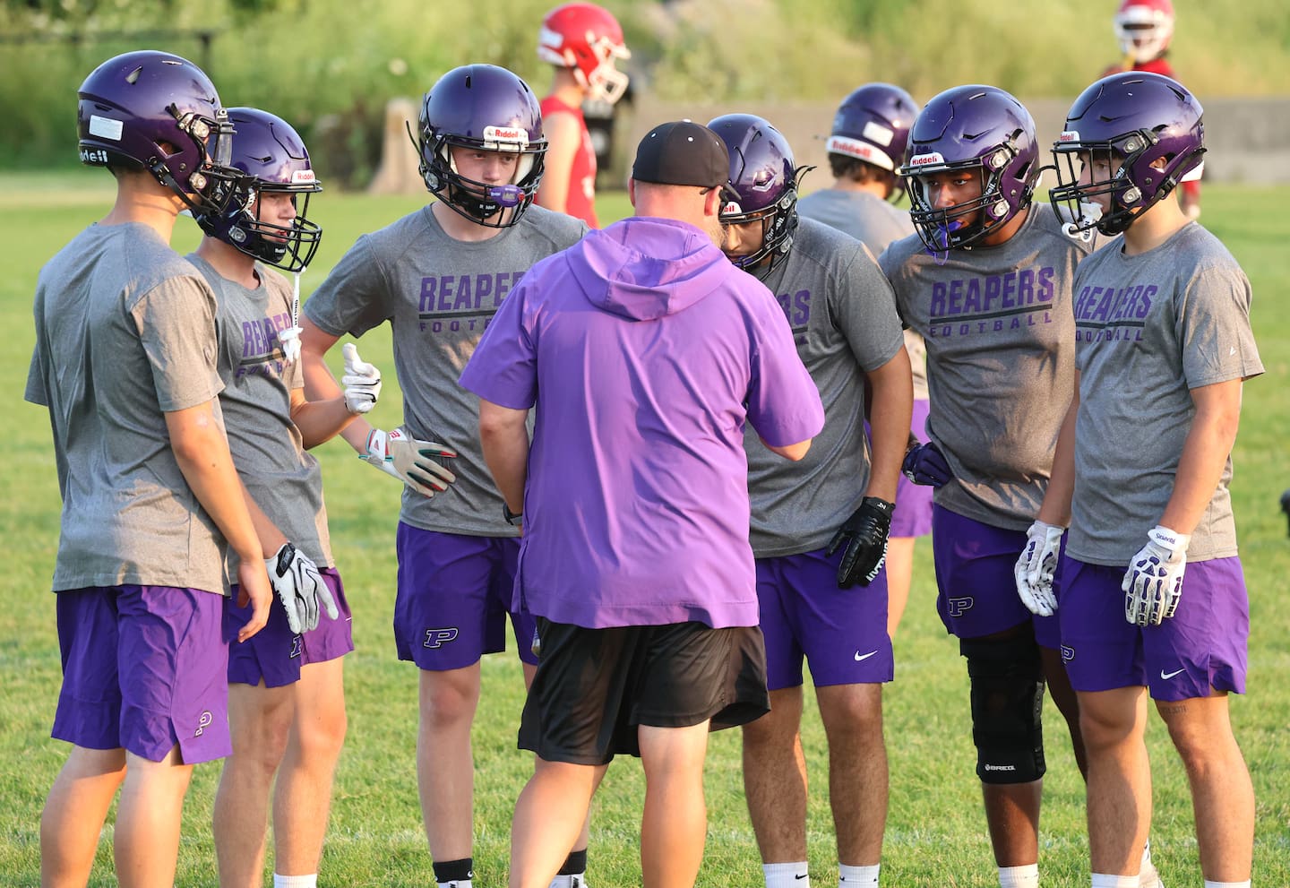 Plano head coach Kyle Tutt makes a play call Tuesday, July 21, 2026, during a game in the 7-on-7 event at Kaneland High School in Maple Park.