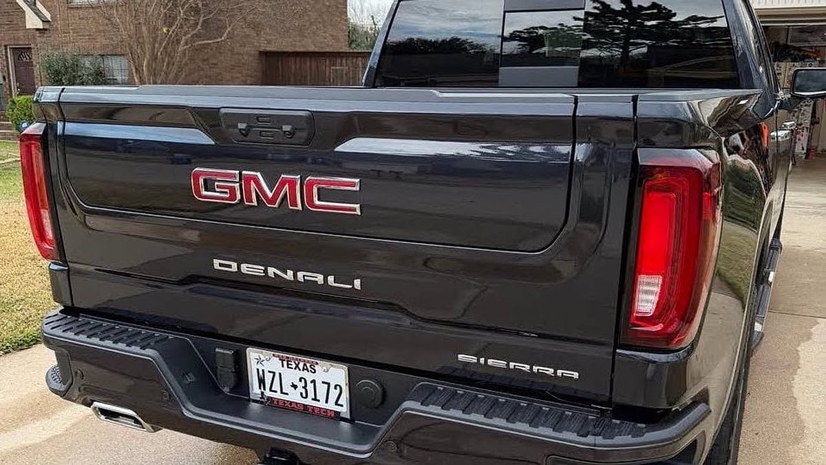 A black 2026 GMC Sierra Denali parked in an Arlington, Texas driveway rear view