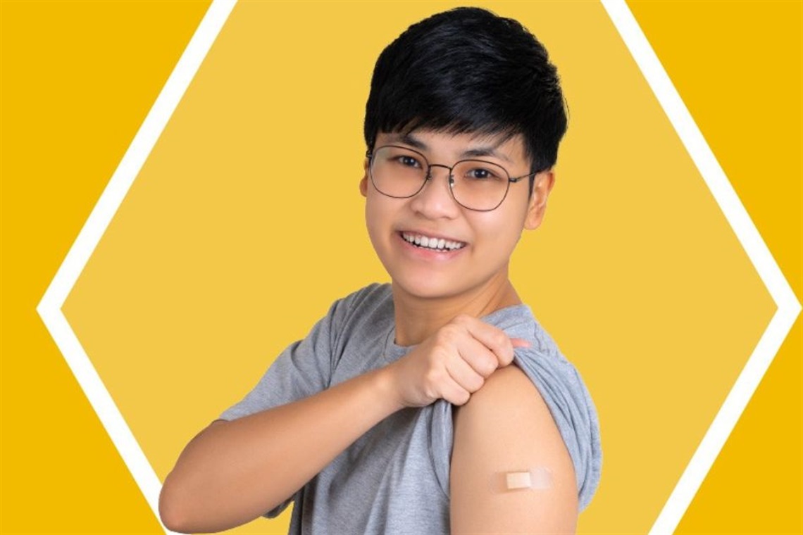 A child showing off a bandage on his arm after getting a vaccine.