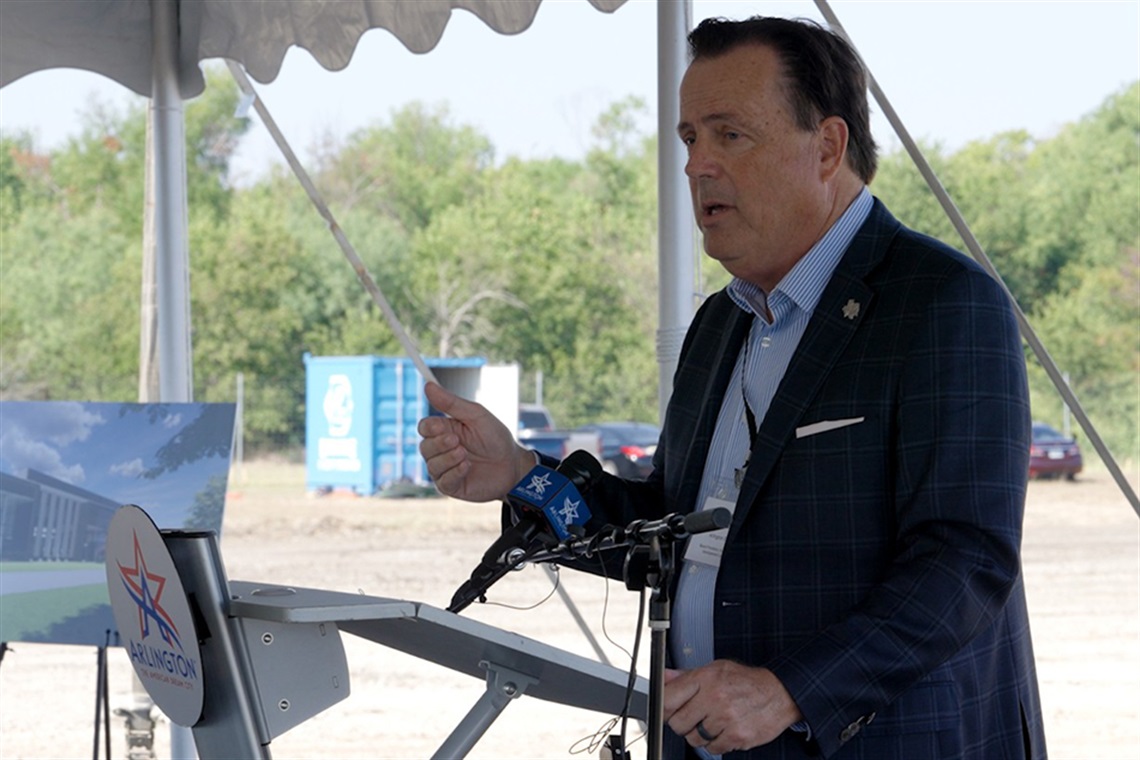 Michael Jacobson speaking on a podium.