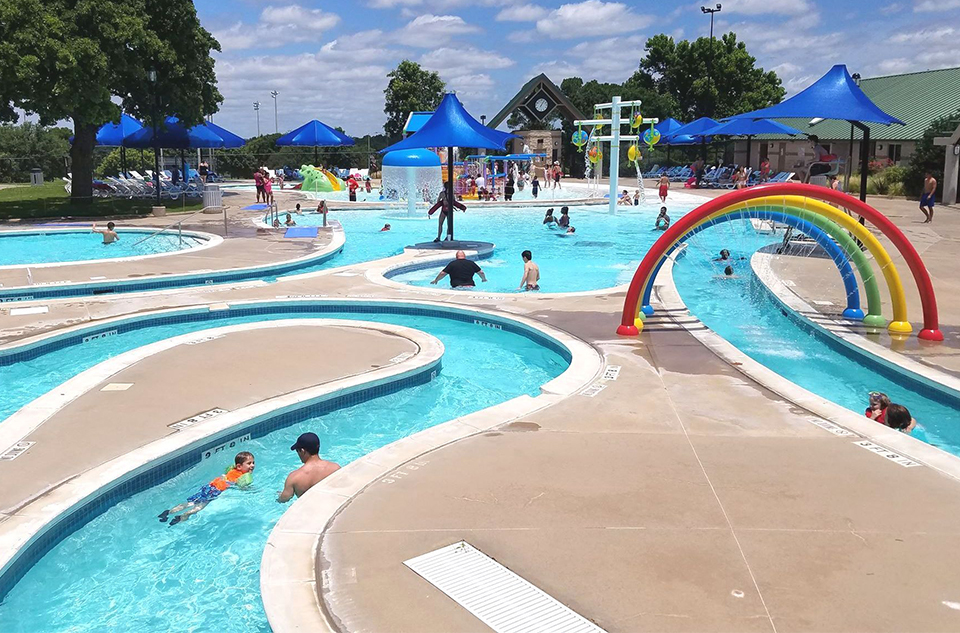 Kids in the pools and splash pads at the Randol Mill Family Aquatic Center