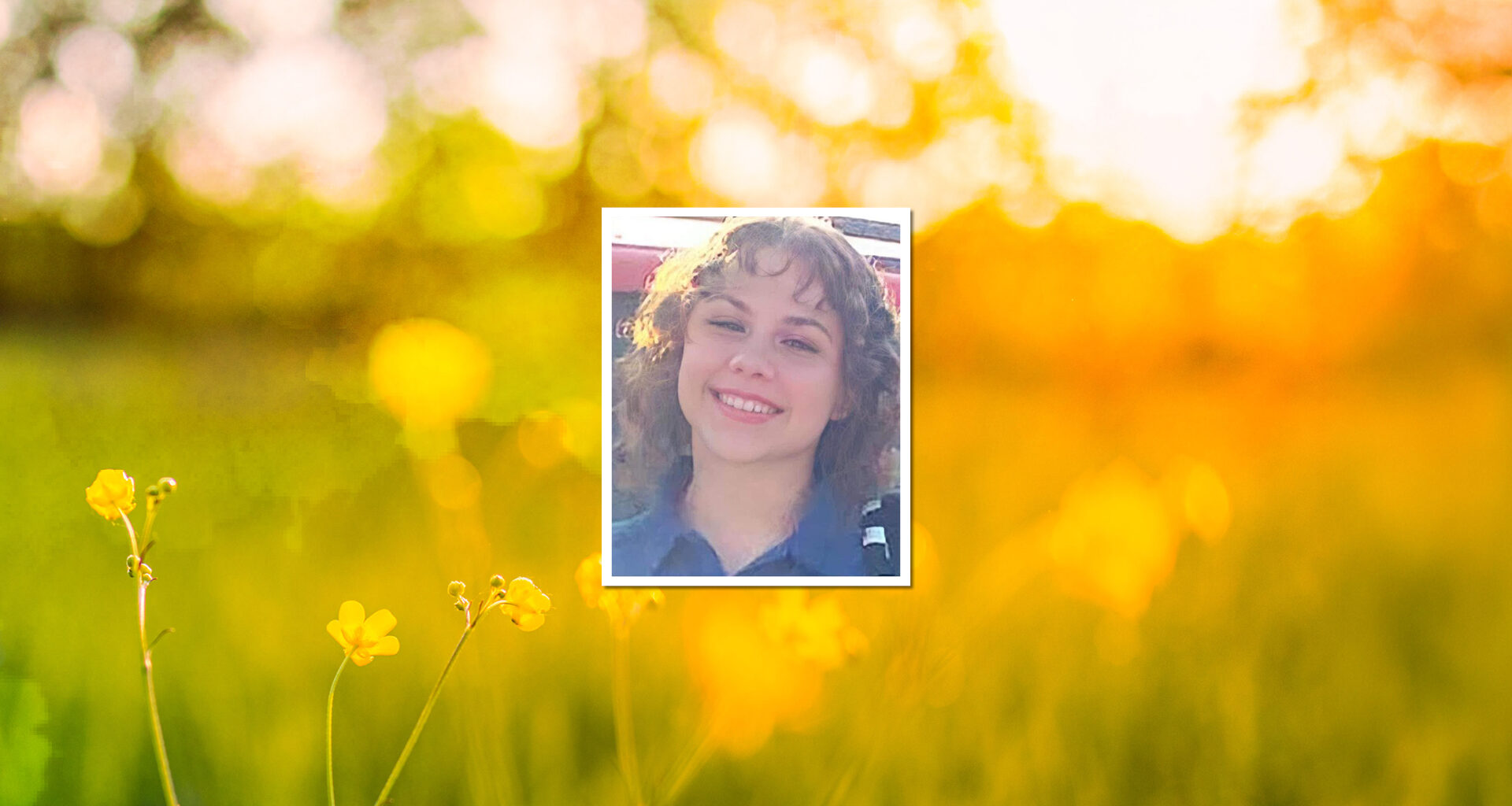 image of teen girl smiling with curly hair, background wildflowers