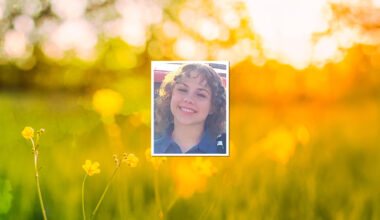 image of teen girl smiling with curly hair, background wildflowers