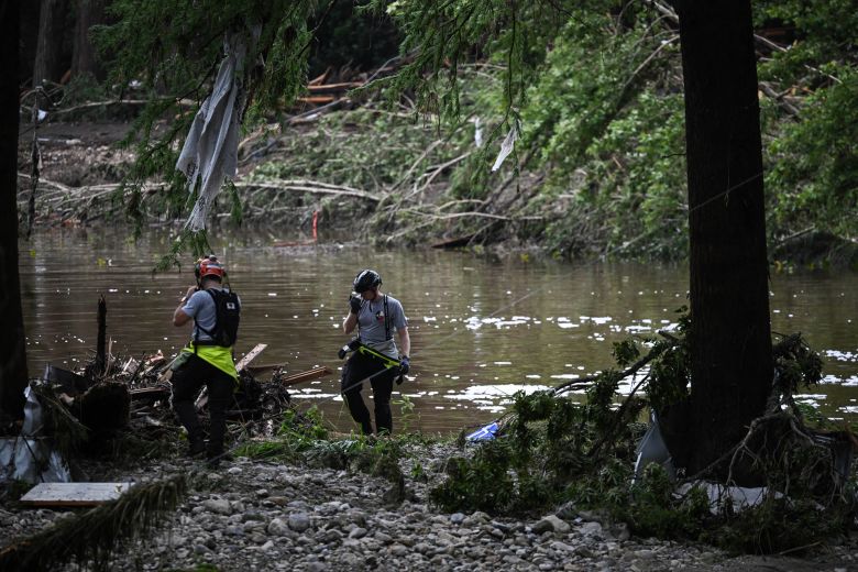 Members of a search and rescue team look for people after flash flooding in Hunt, Texas, on July 5, 2025.