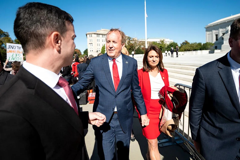 Texas Attorney General Ken Paxton and his wife Angela leave after speaking to pro-life activists outside the Supreme Court on Nov. 1, 2021Credit: Bill Clark/CQ-Roll Call, Inc via Getty