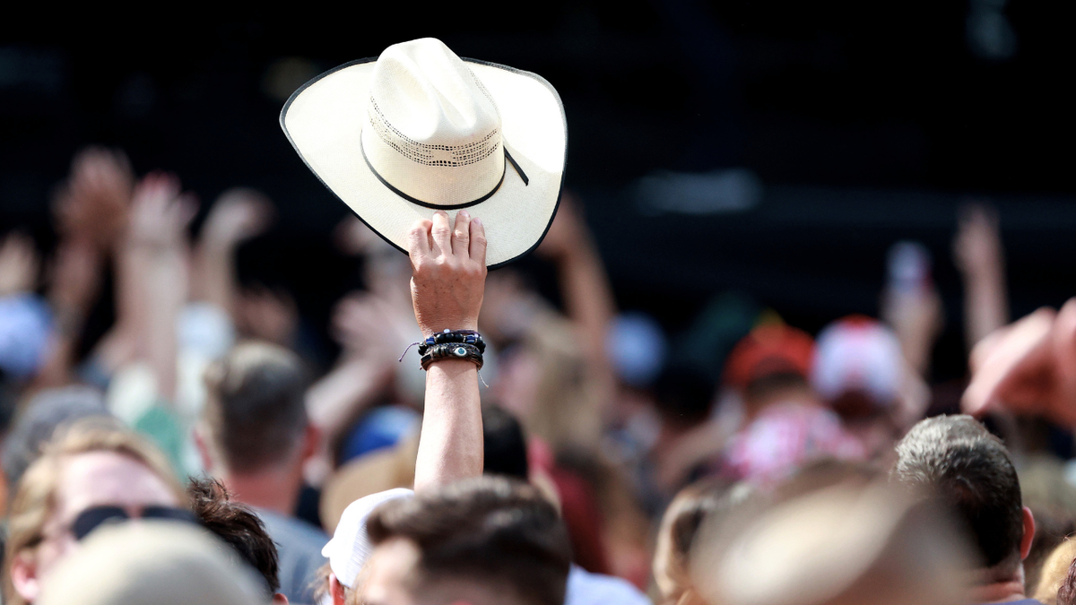A fan holds up a cowboy hat before Little Big Town performs during the 2023 March Madness Music Festival at Discovery Green on April 2, 2023 in Houston, Texas.