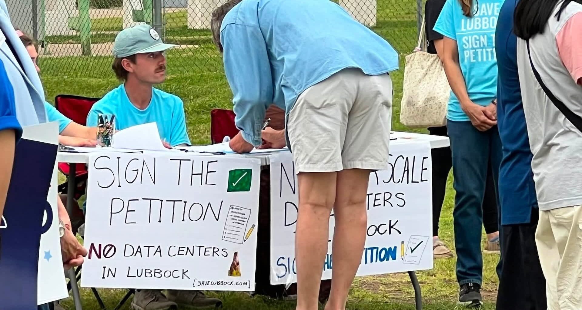 People signing a petition to keep data centers out of Lubbock, Texas.