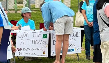 People signing a petition to keep data centers out of Lubbock, Texas.