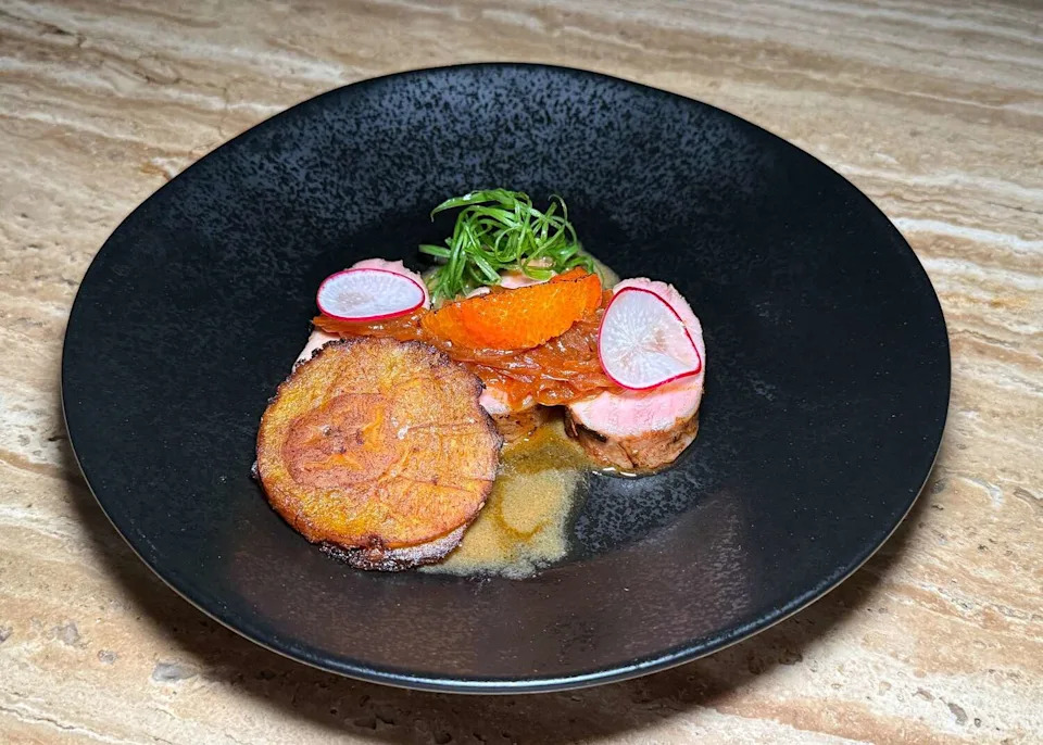 Pernil and tostones at Ensemble, a private supper club in Houston. (Bao Ong / Houston Chronicle)