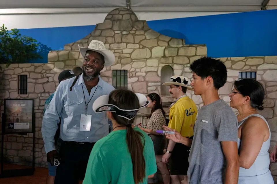 At the Texas display, Leonard Riddic greets visitors Friday in front of an Alamo exhibit during the Great American State Fair in Washington. (Carolyn Kaster/Associated Press)